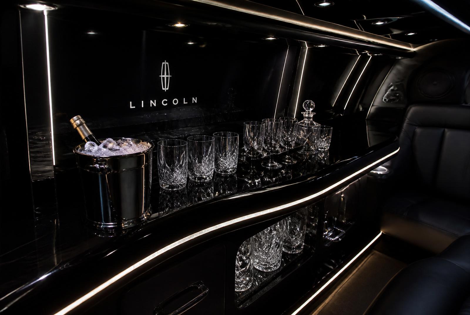 Chilled bar with crystal glassware inside the black Lincoln MKT limousine